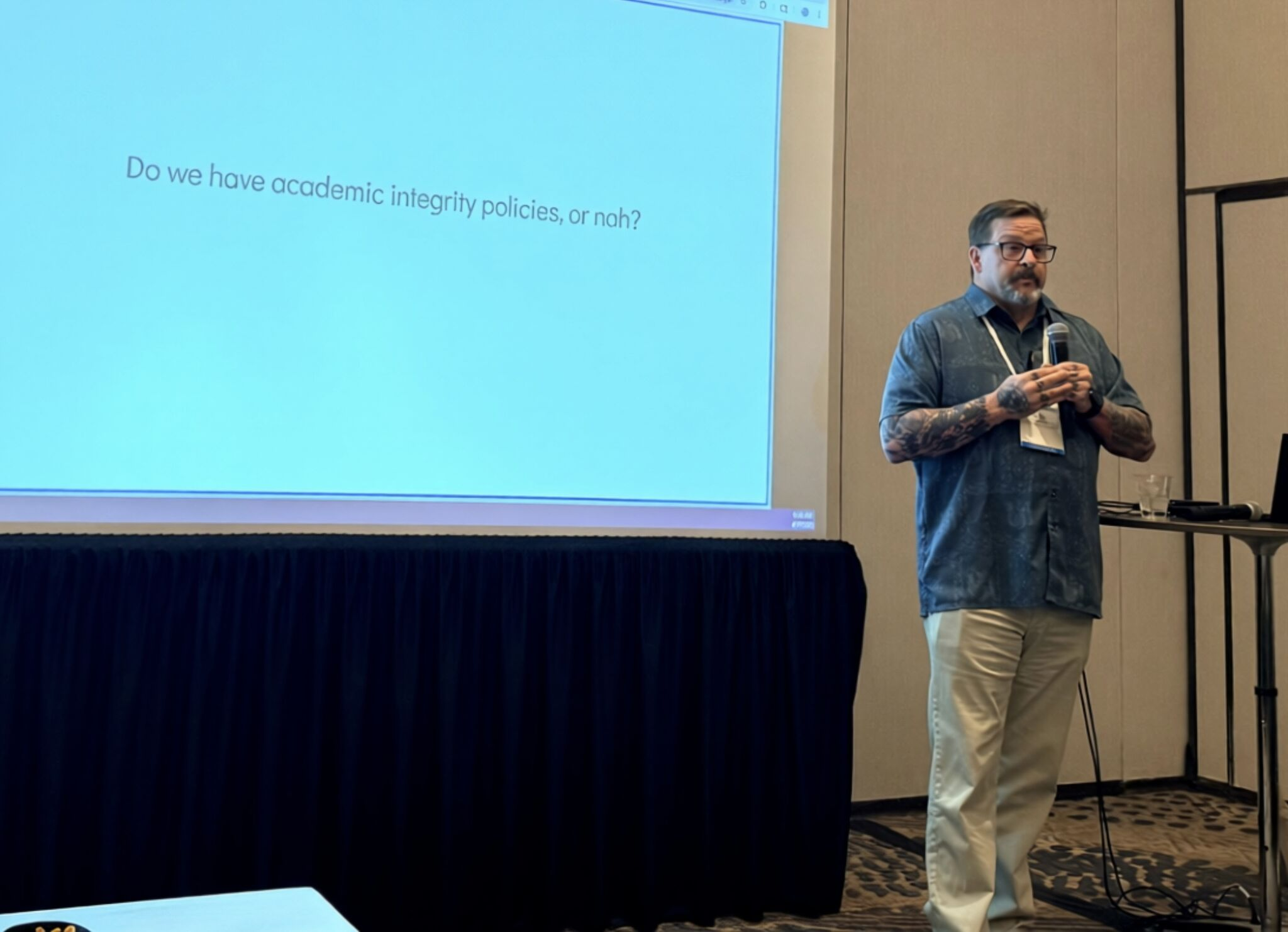 Kevin Gannon stands next to a slide that reads: "Do we have academic integrity policies, or nah?