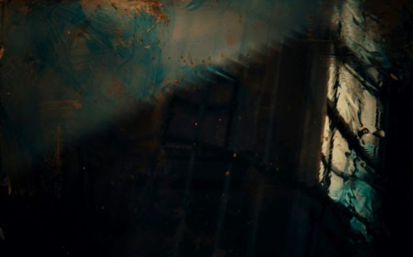 Abstract image - perhaps a window or a door with panels? Dark shadows and rusty colors