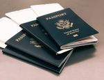 a photo of multiple US passports stacked on top of each other- each has a boarding pass inside it