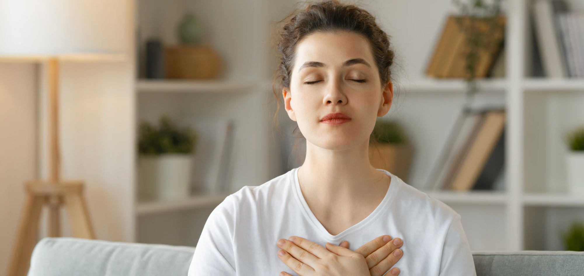 Peaceful woman with eyes closed and hands on EFT tapping points