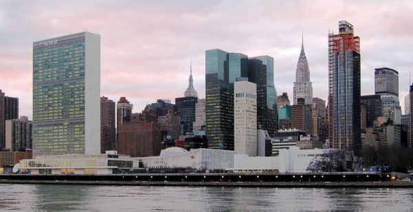 Image depicting the U.N. Headquarters Building and the New York City skyline.