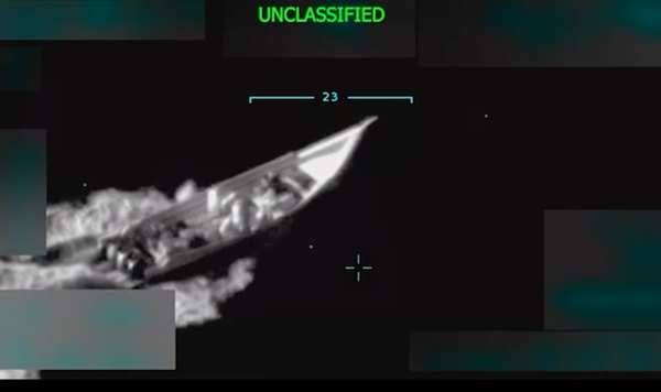A black and white image of a small boat traveling through the ocean, with the word "UNCLASSIFIED" at the top in green.