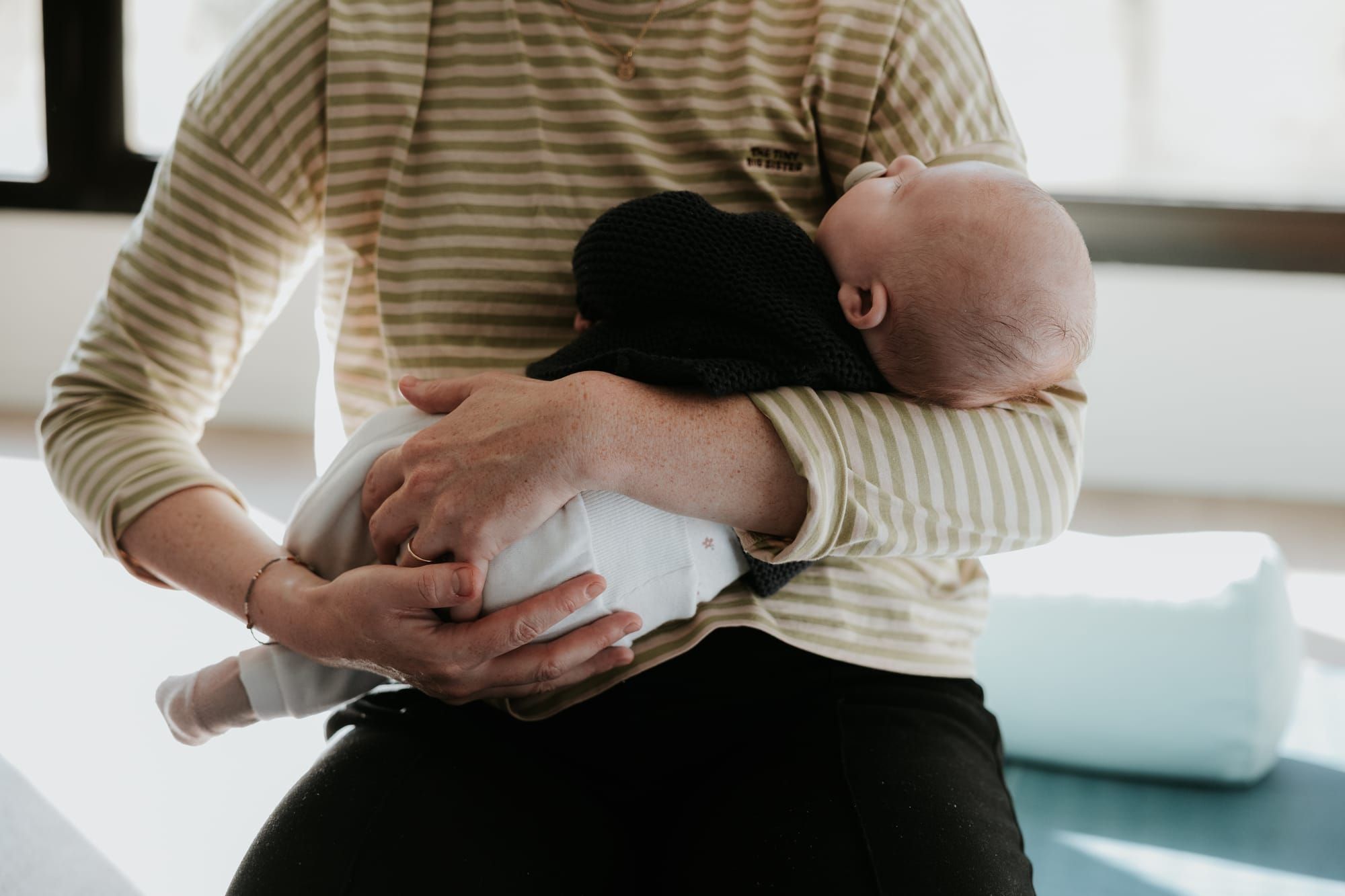 Mère tenant son bébé contre elle lors d’un moment de peau à peau favorisant le lien et le réconfort du nourrisson