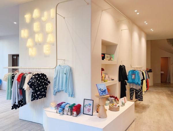 Boutique Tajinebanane avec vêtements d’allaitement modernes et colorés exposés dans un espace lumineux et minimaliste