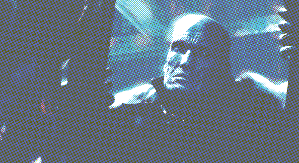 The face of Mr.X from Resident Evil 2 Remake, as he forces his way through metal bar towards the player.