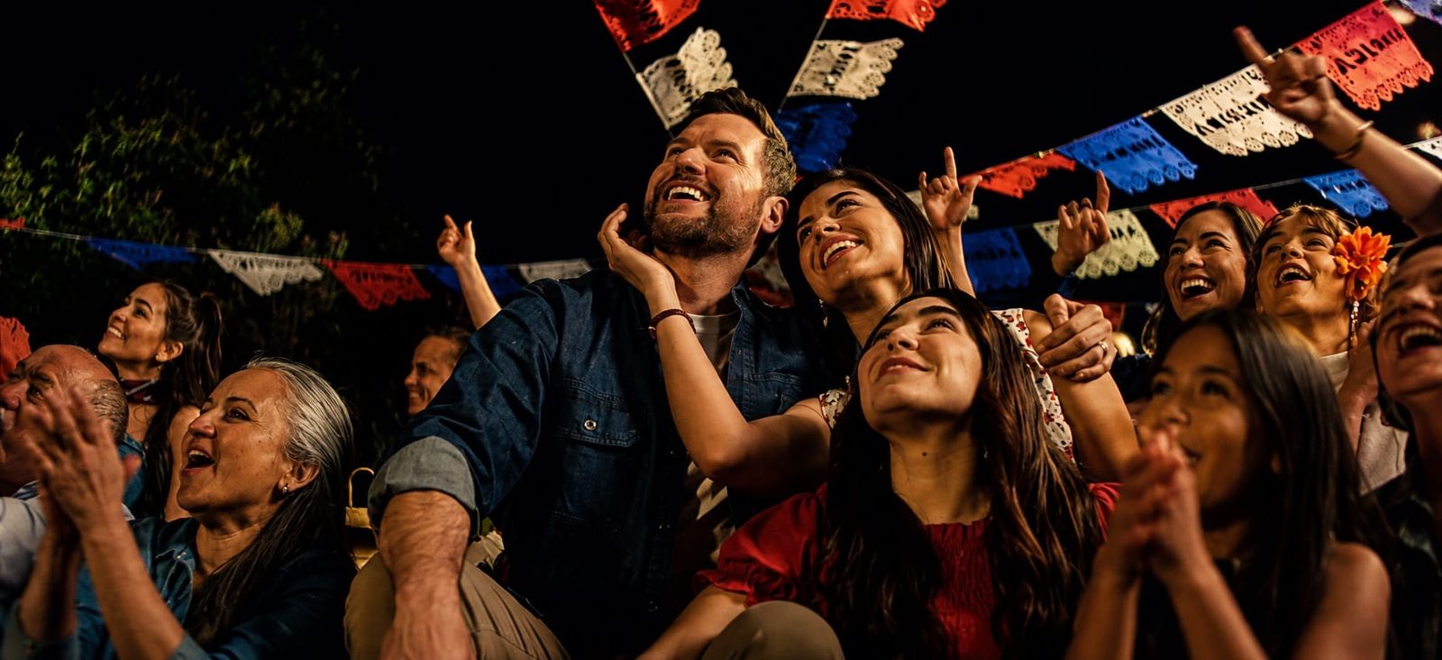 Neighbors celebrate together under papel picado, a still from Brotherhood