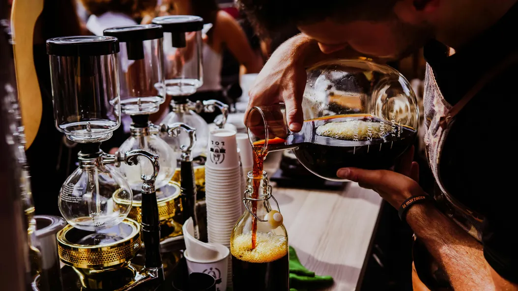 Part time Barista pouring coffee in a jug