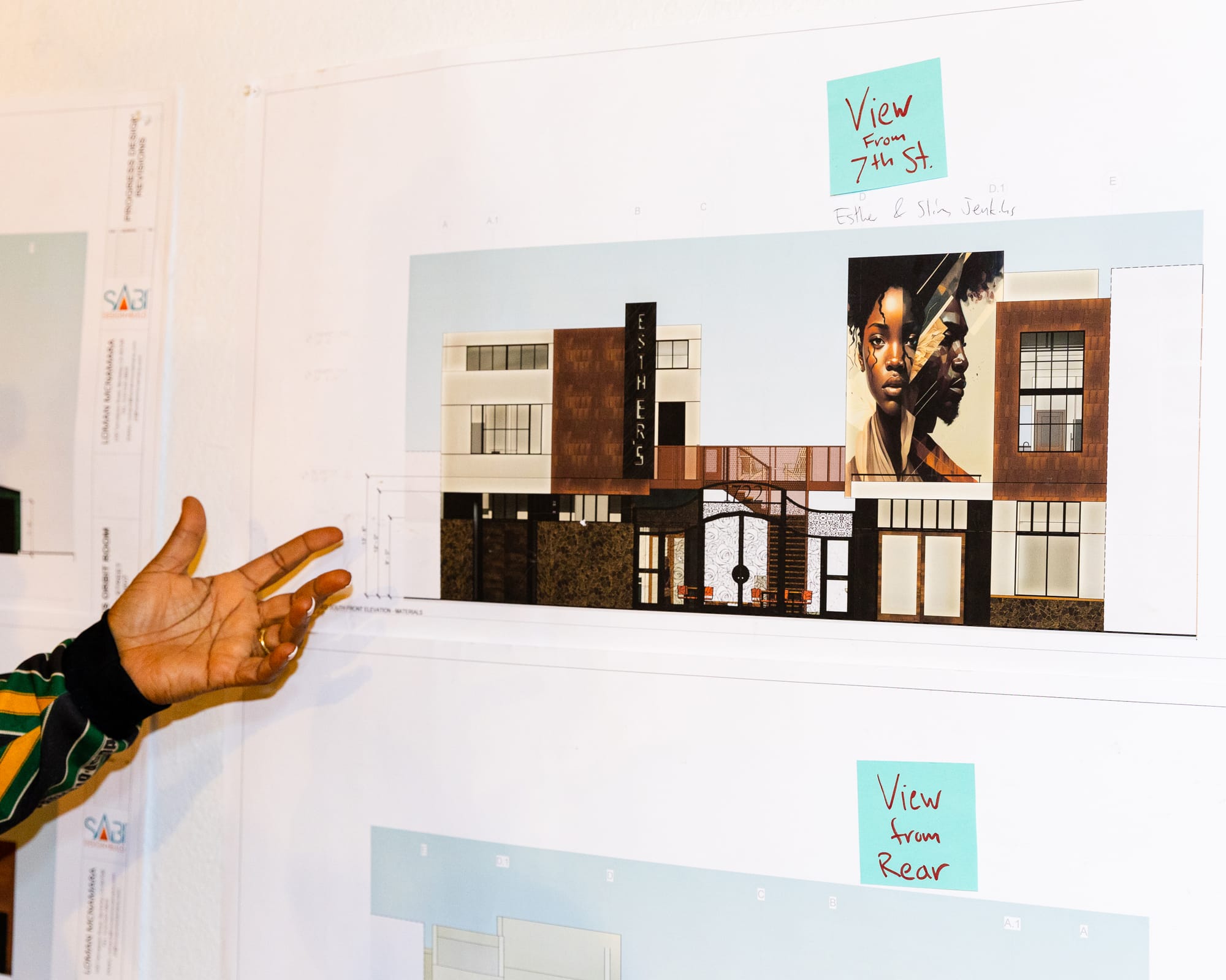 Noni Session's hand gestured toward an illustrated mockup of a renovated building.
