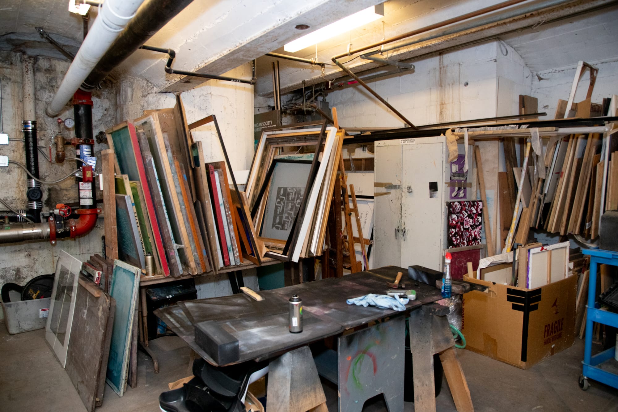 Stacks of empty frames lean against a stand waiting for artists to use them.