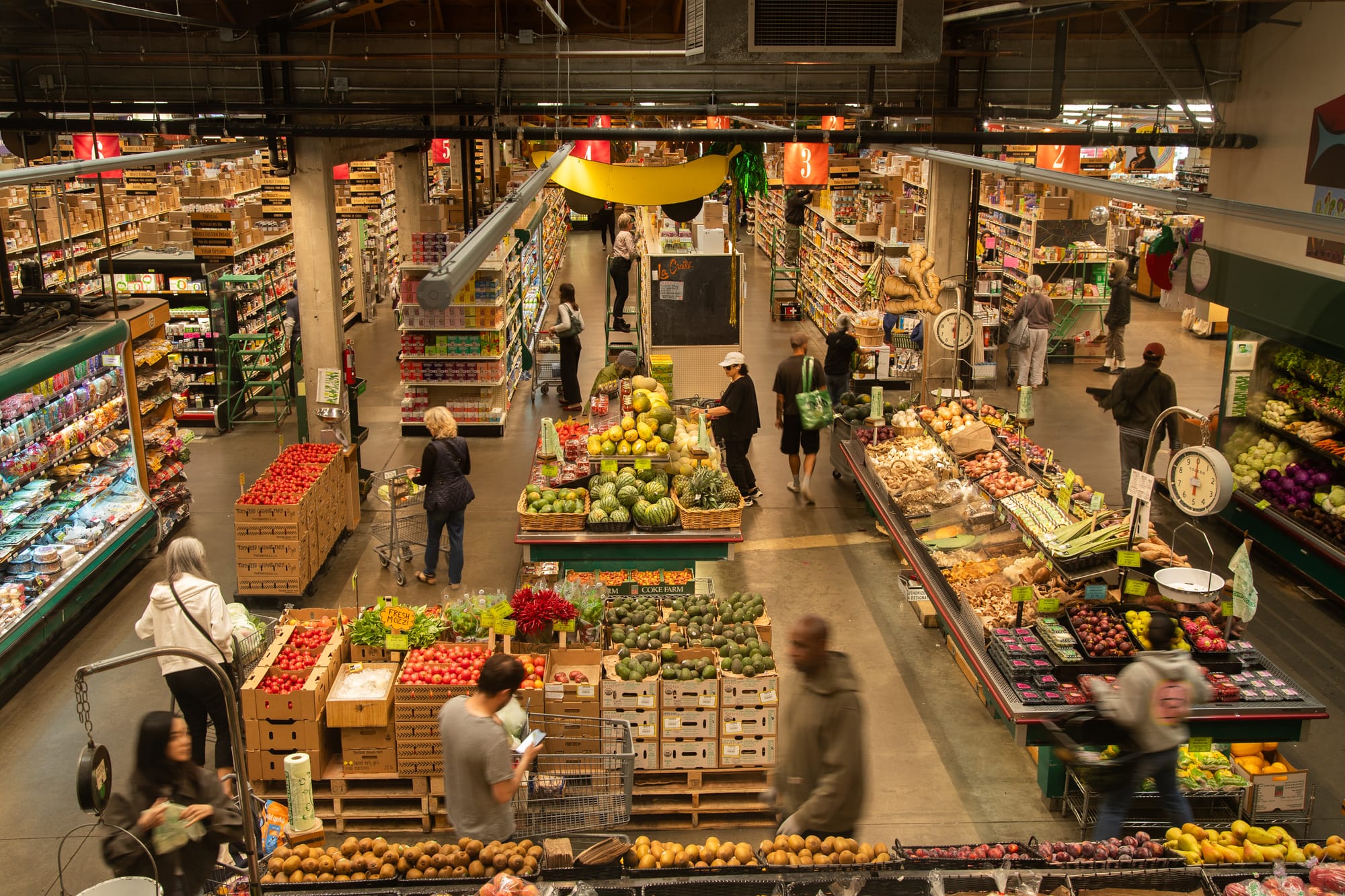 people walk around a grocery store