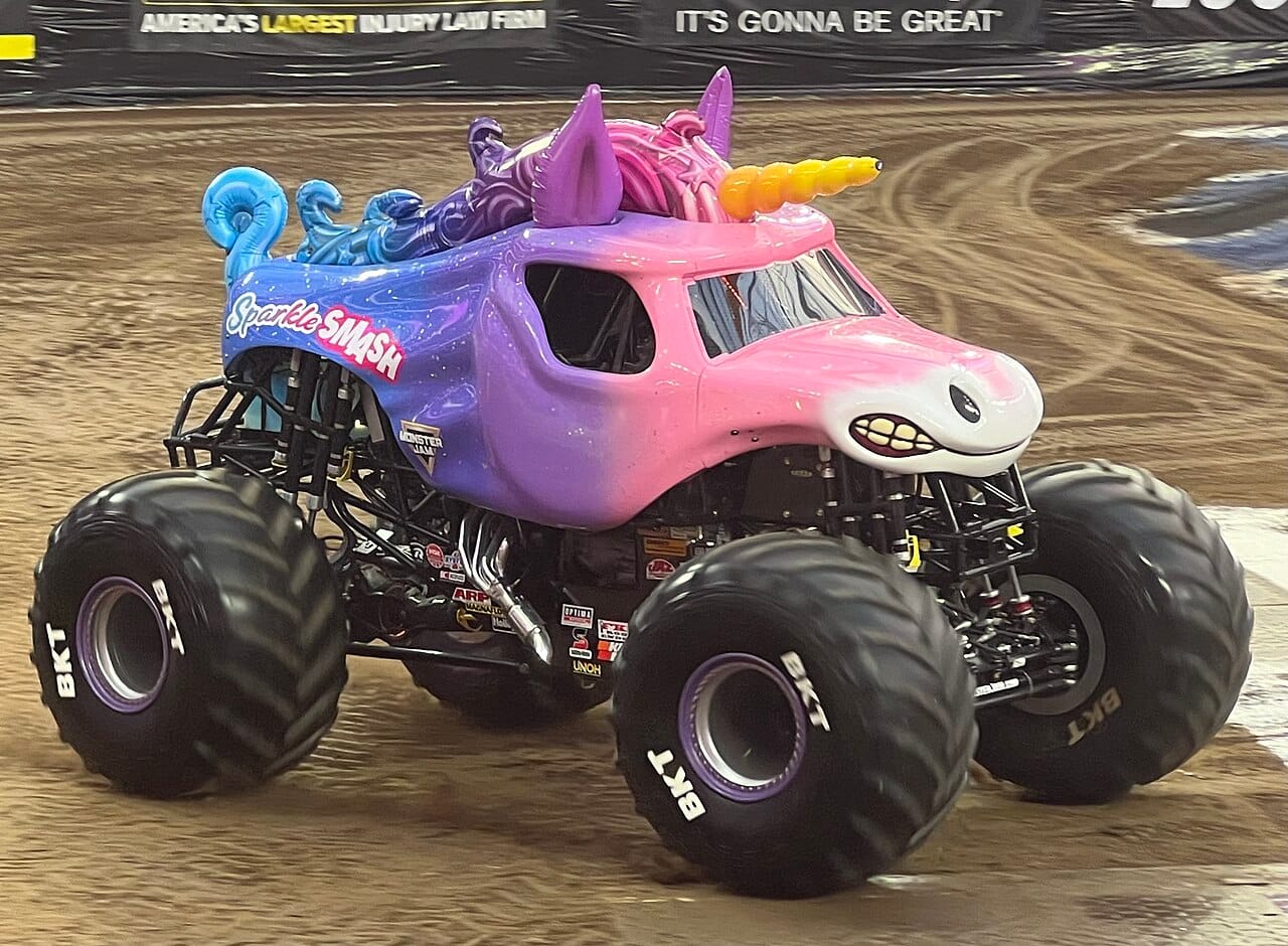 A close-up of Sparkle Smash —&nbsp;a blue, purple, and pink monster truck in the shape of a unicorn. 