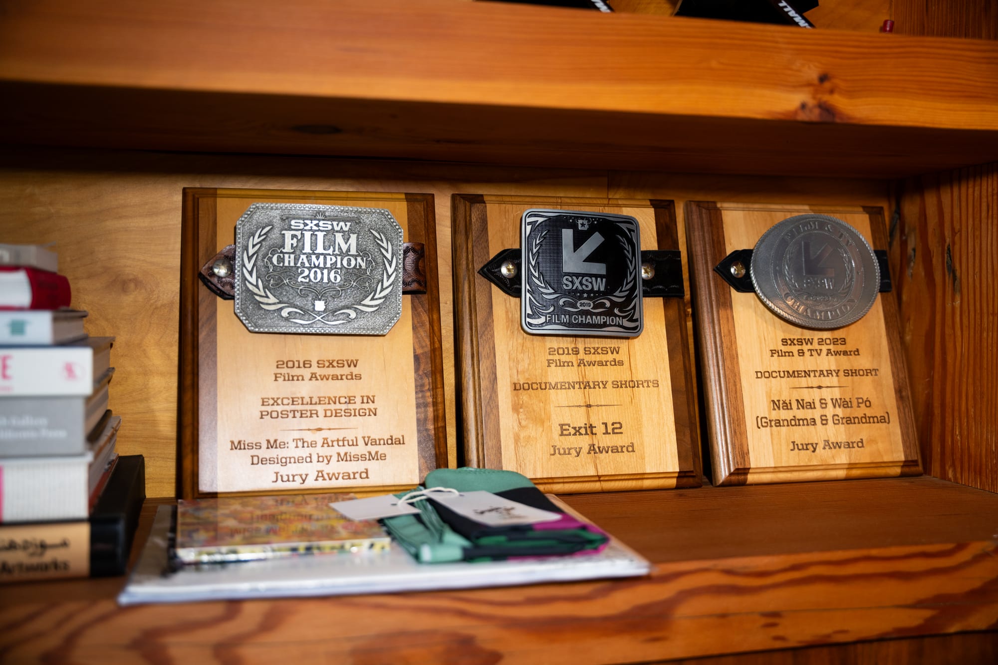 Three awards from SXSW on a shelf.