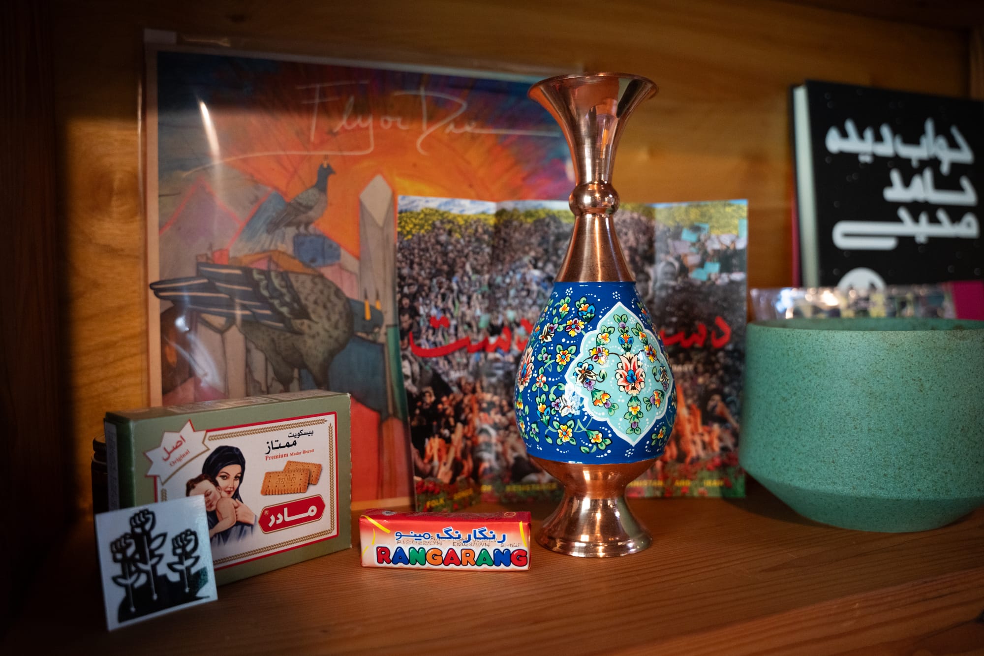 Iranian objects, including a vase, cookie box, and artwork.