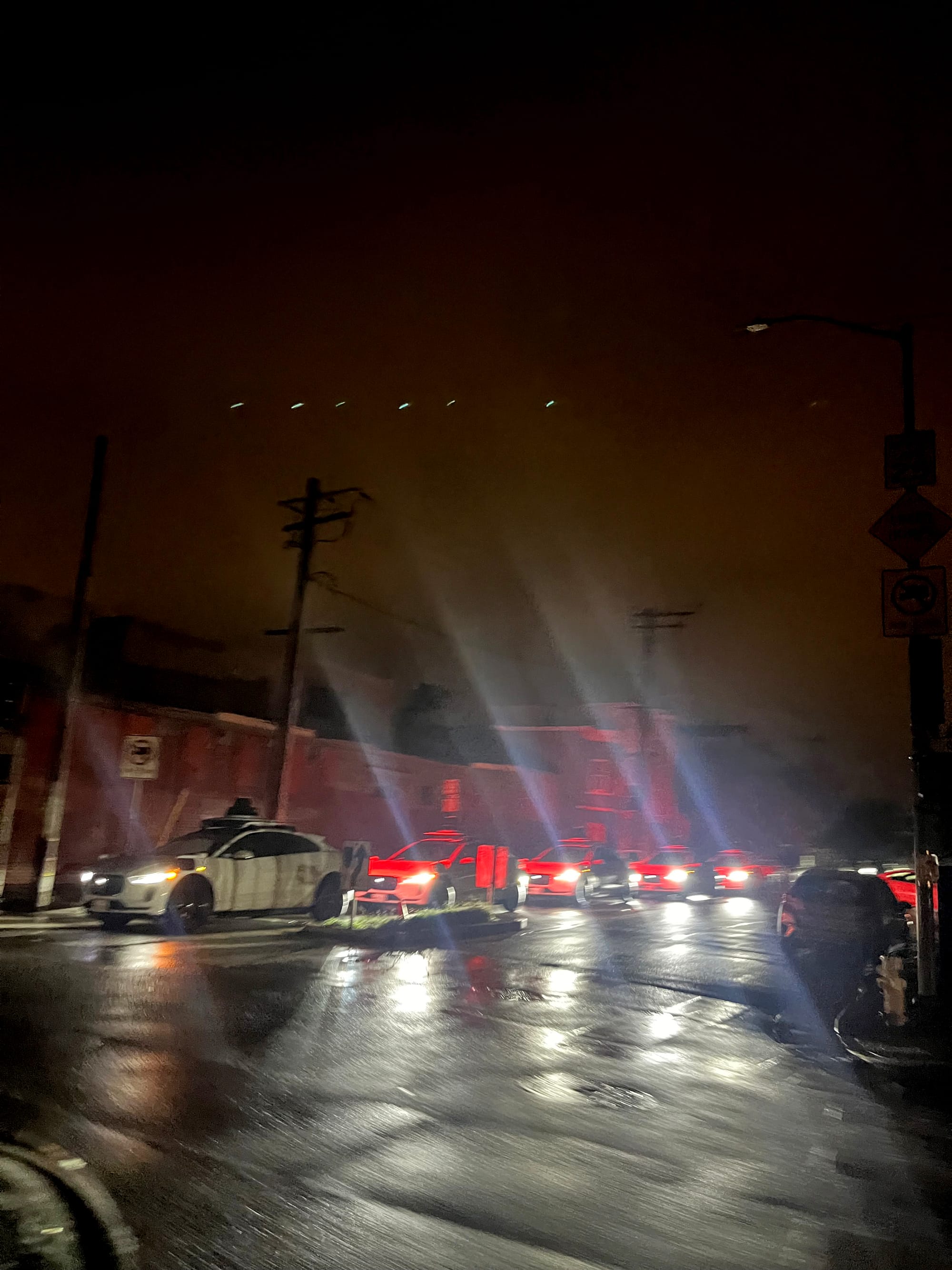 white Waymo cars all lined up and not moving during a power outage in San Francisco