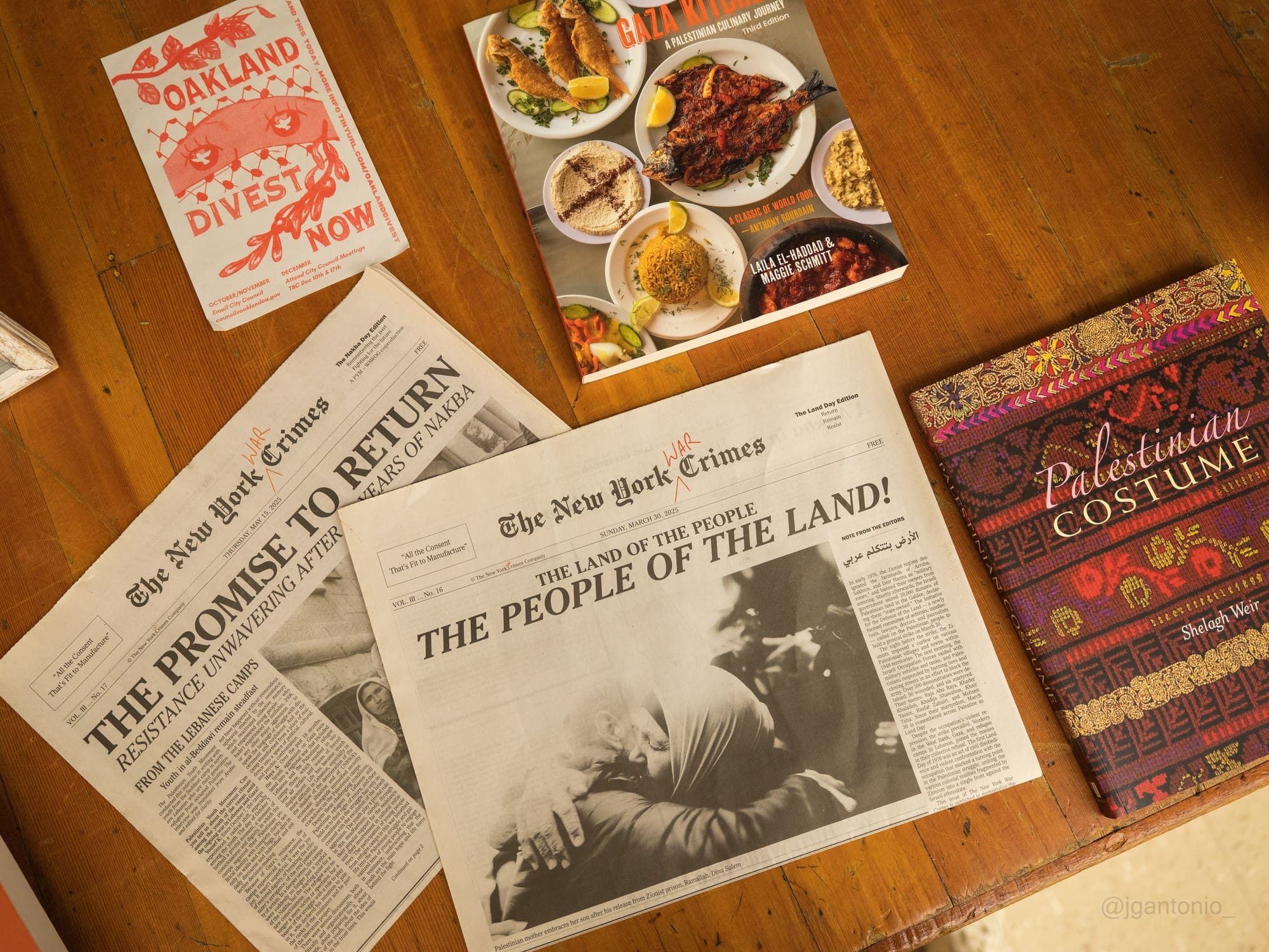Overhead shot of cookbooks and periodicals such as the New York War Crimes.