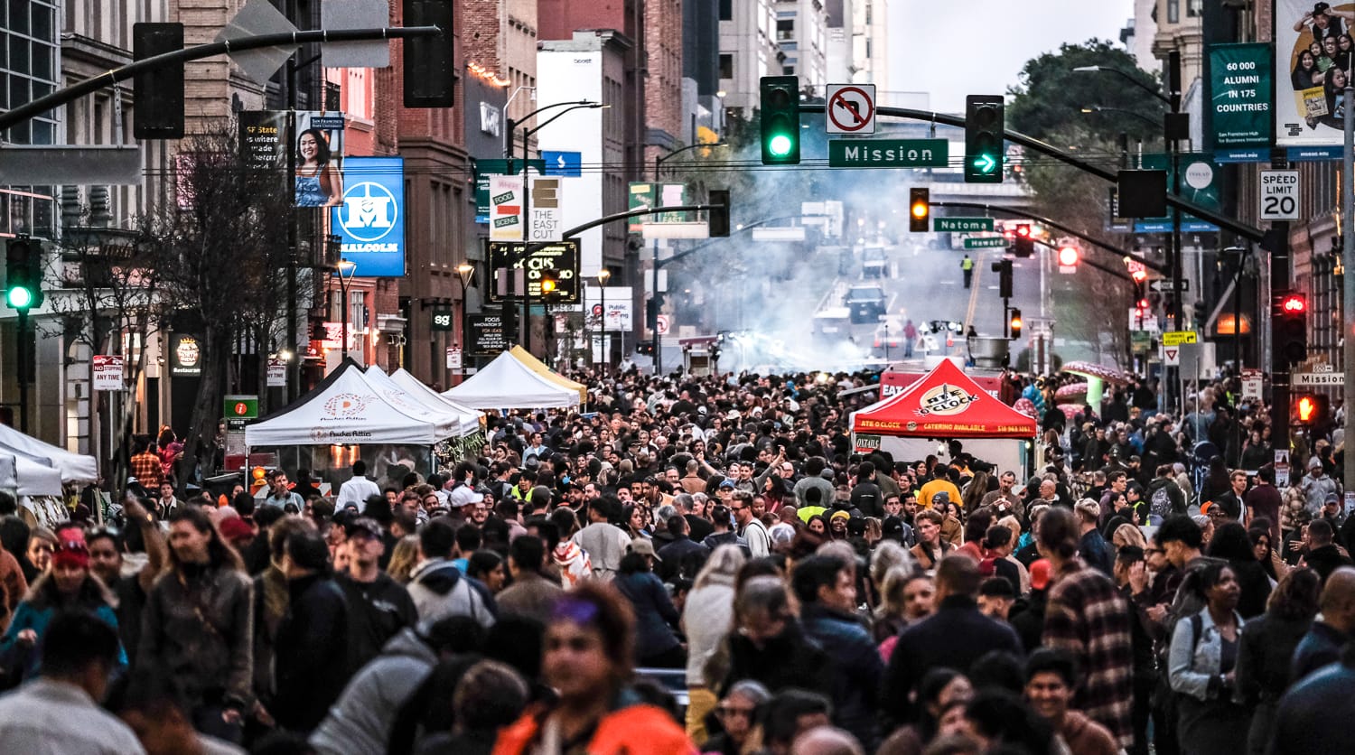 a large crowd at a street party