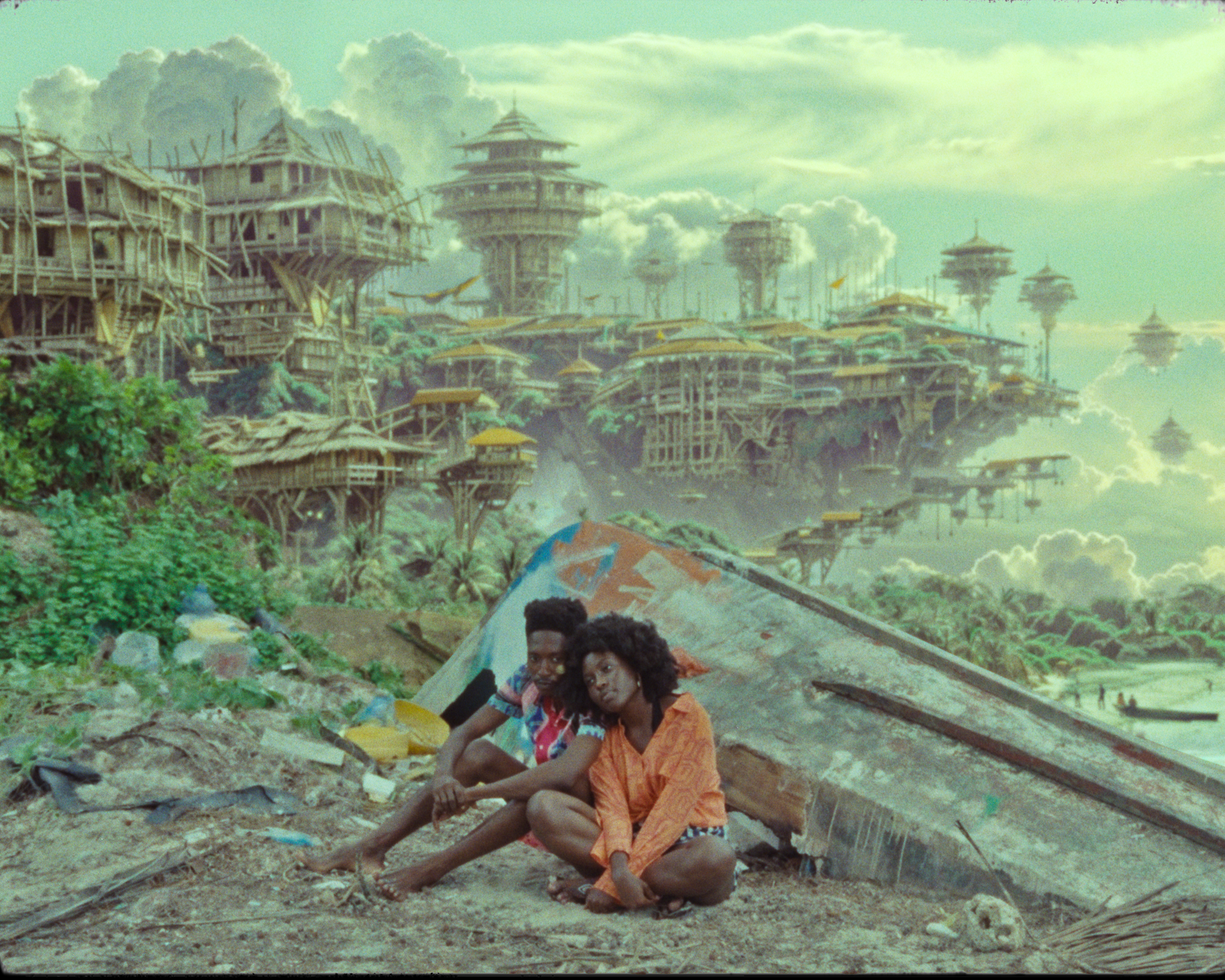 two young African people sit on the ground amid a retrofuturistic city