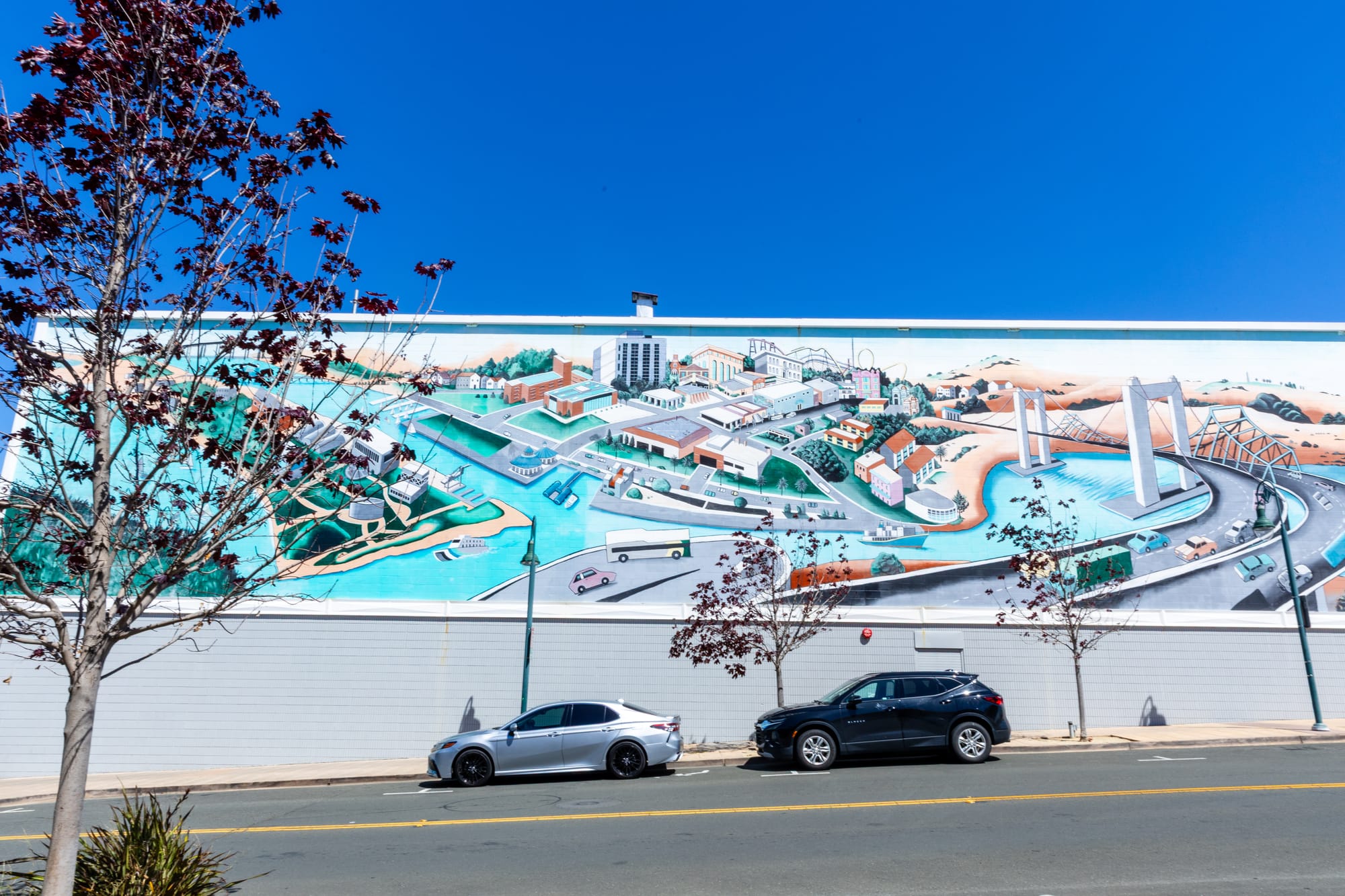 A colorful mural stretching across an entire building, showing an aerial view of Vallejo.