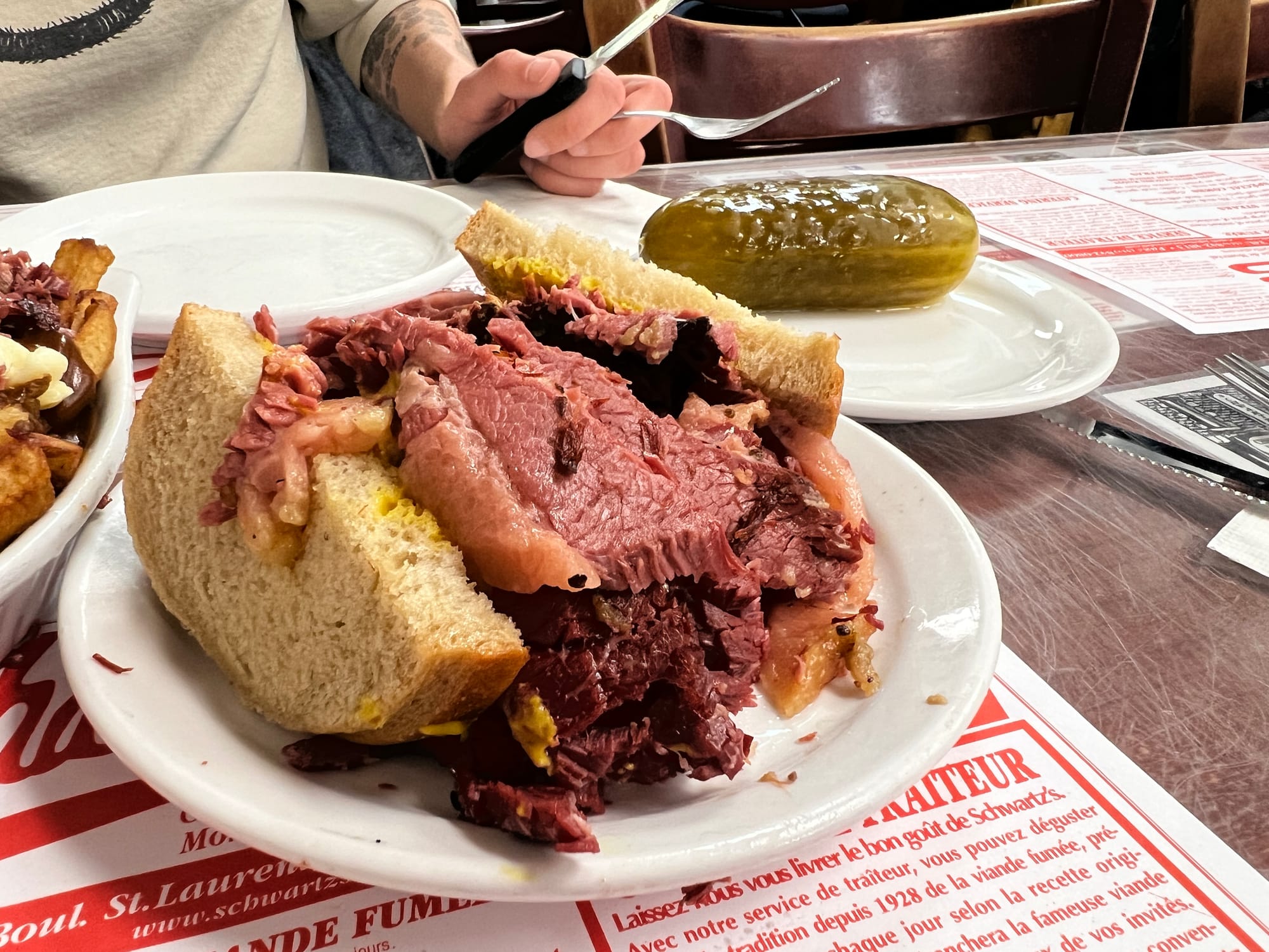 A sandwich filled with pink cured smoked brisket.