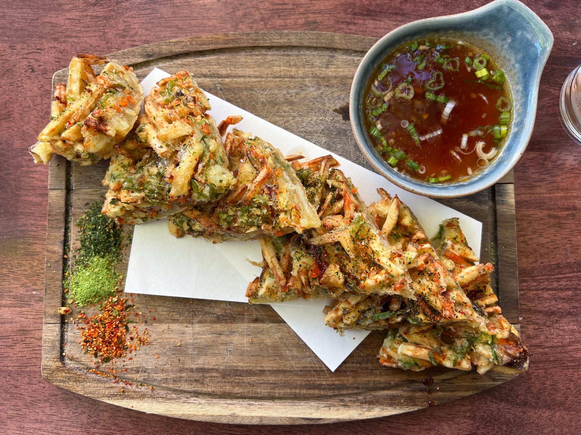 Fried vegetables in a batter, formed into a cake and cut into wedges.