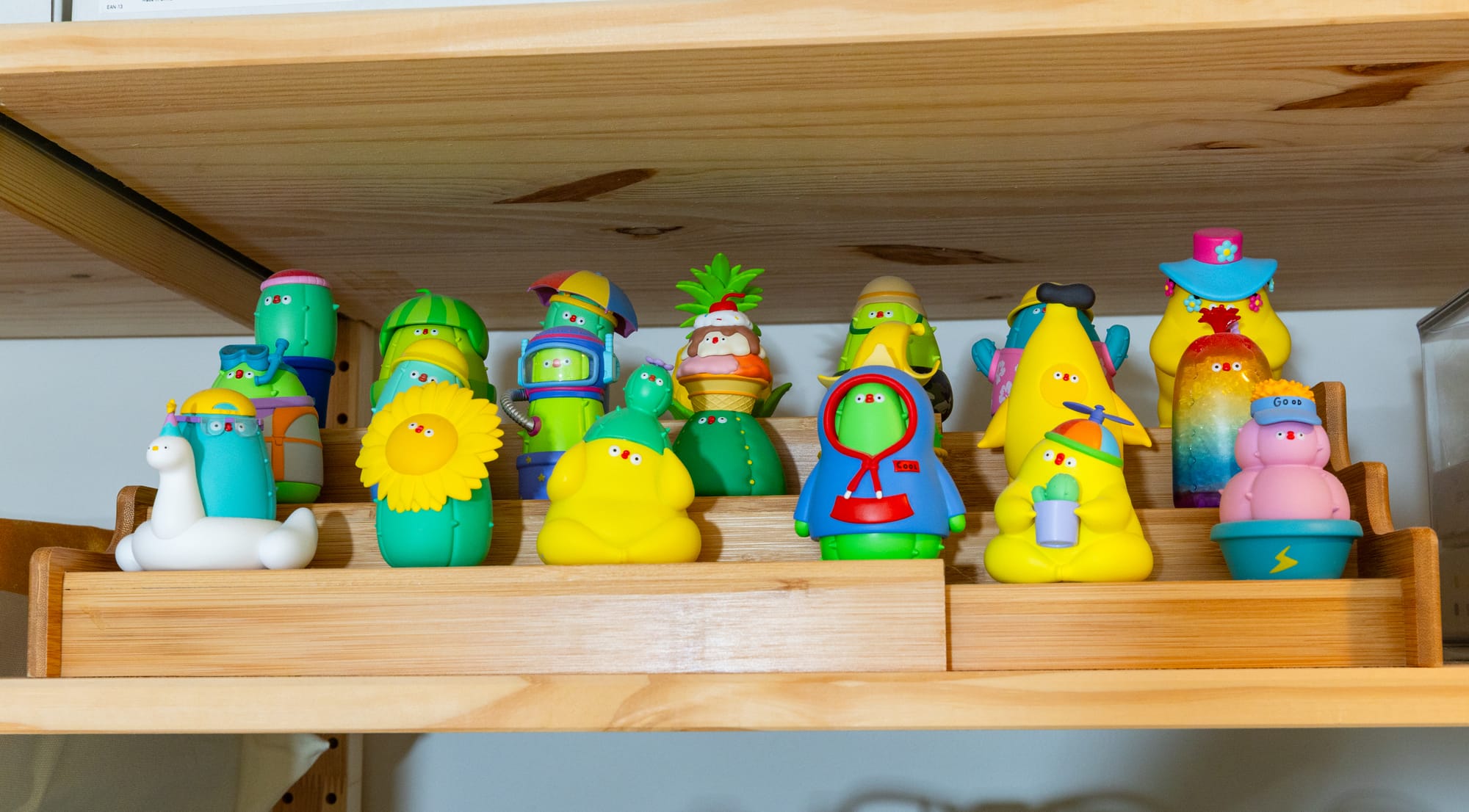 A wooden tiered shelf holding 20 small figurines.