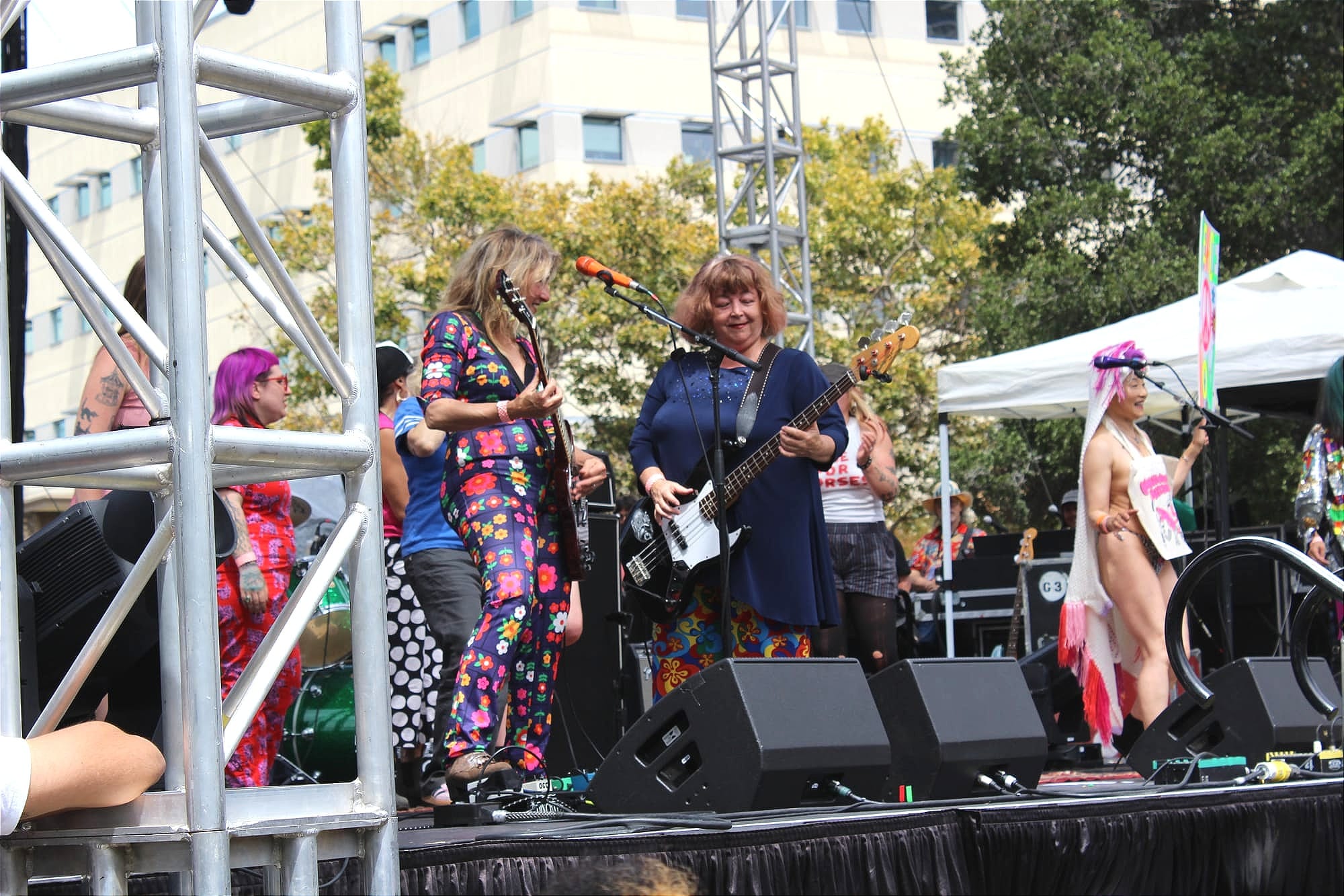 a band of women in their 50s and 60s perform on a festival stage
