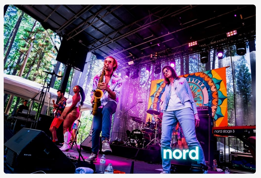 a creepy AI image of a band onstage where one person is clearly AI