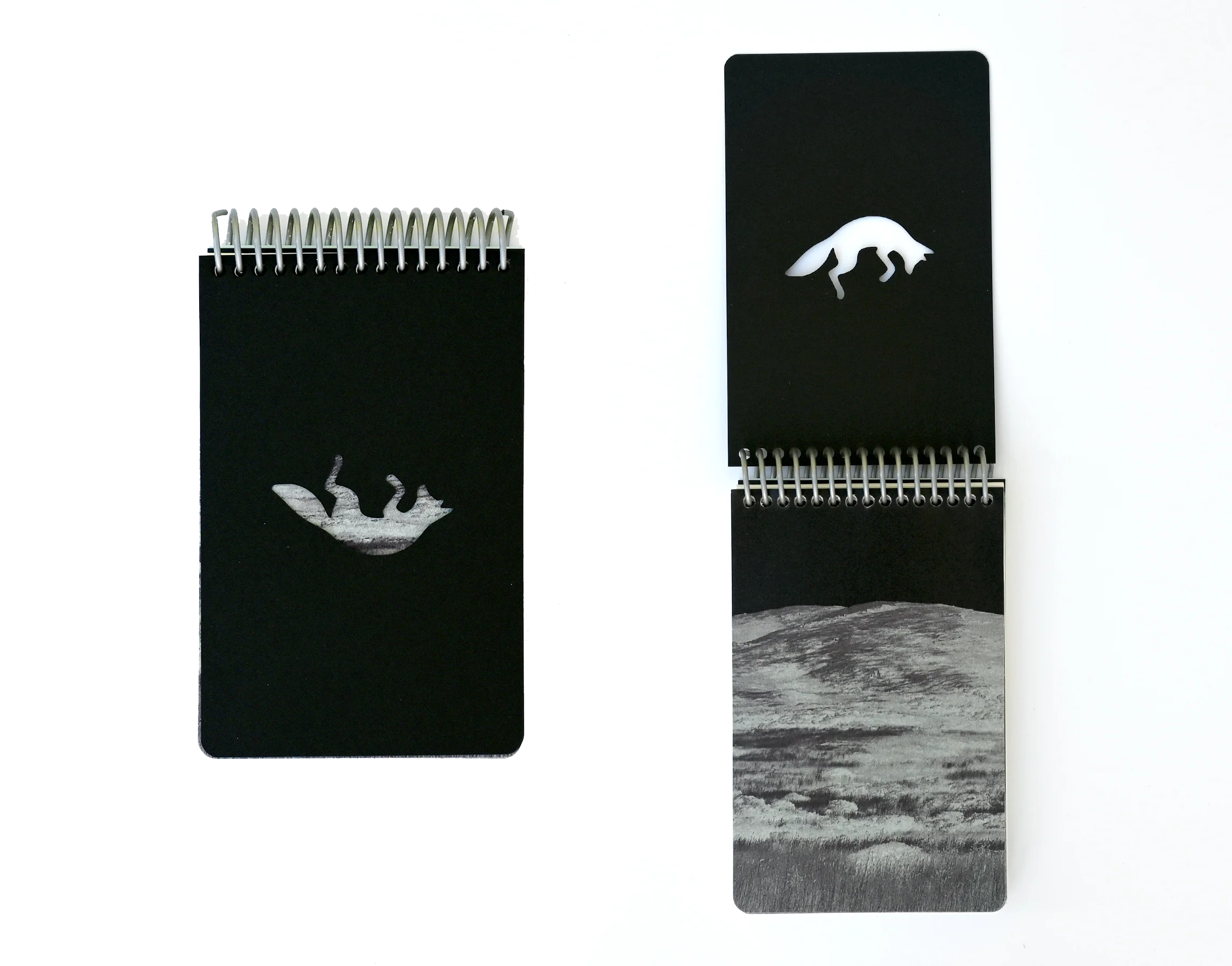 two images of a book that looks like a black reporter's notebook, with spiral at the top and a cutout of a coyote