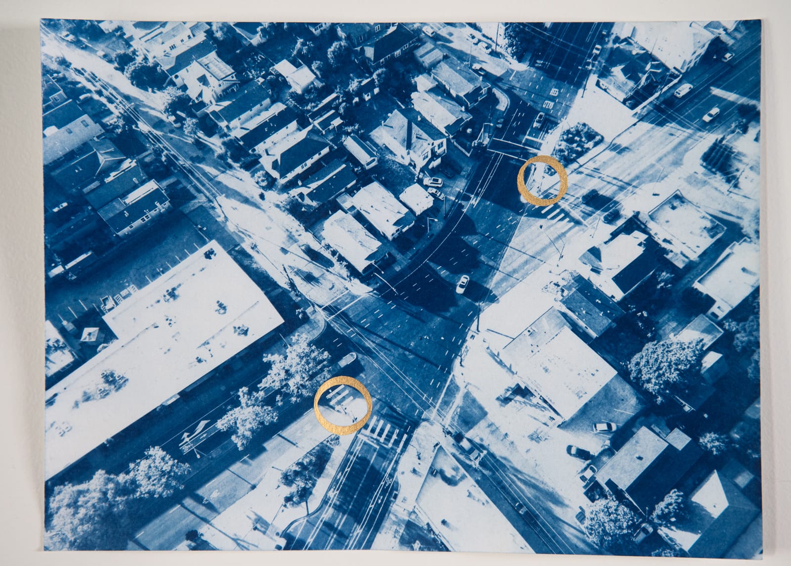 a blue and white cyanotype of an intersection in Oakland, with Flock cameras circled
