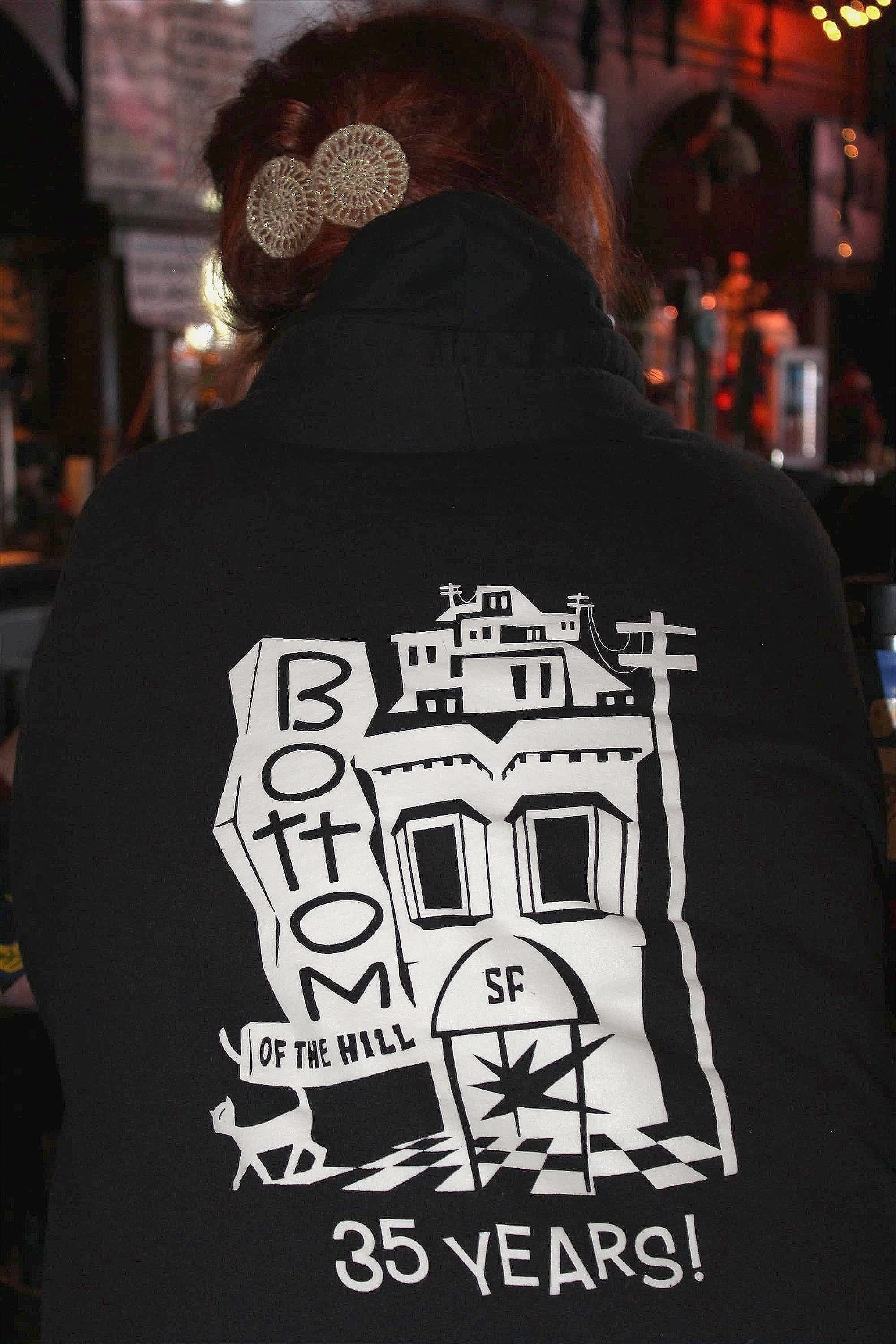 the back of a black sweatshirt that reads 'bottom of the hill 35 years!'