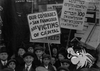 A photo from the Sympathy Labor Parade in 1916 . Photograph shows a crowd with a sign reading "Our comrades in San Francisco are victims of apital." 