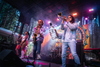 A band plays on a stage lit with purple lighting, in a badly-rendered AI image. One person has an arm holding a large glass bottle extending out of his side