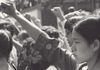 A girl raising her fist with a pensive expression.