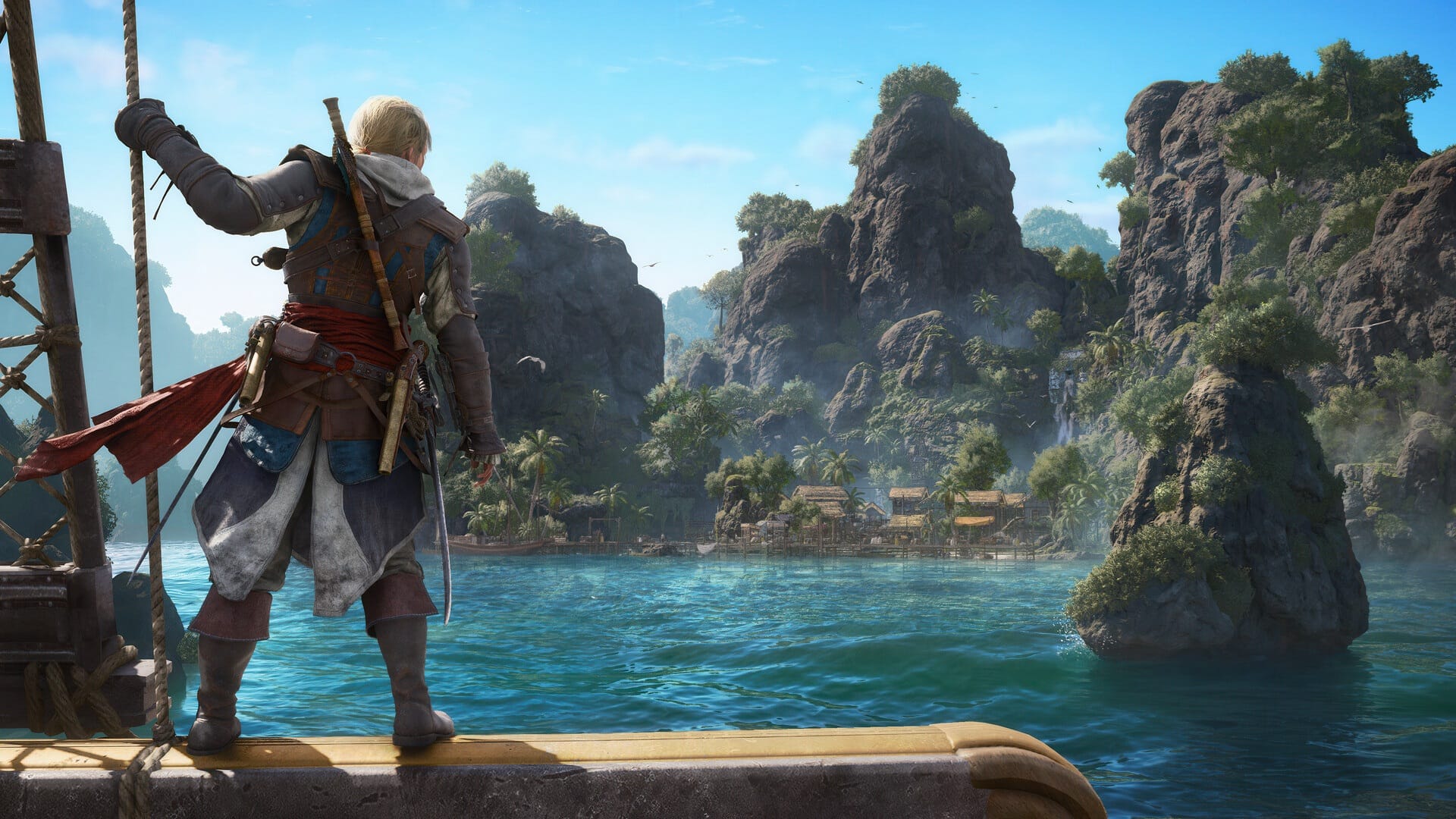 A pirate standing on the edge of a ship holds on the rigging, looking out over water to a small village.