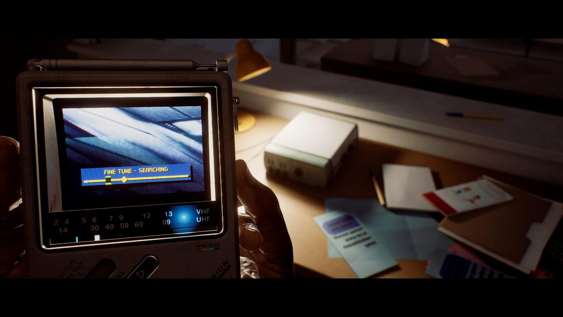 A handheld CRTV in Silent Hill: Townfall, tuning into a signal