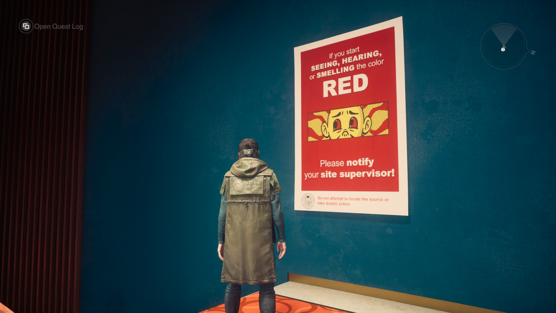 Dylan Faden in Control Resonant, standing in front of a poster that says "If you start SEEING, HEARING, or SMELLING the color RED, please notify your site supervisor!"