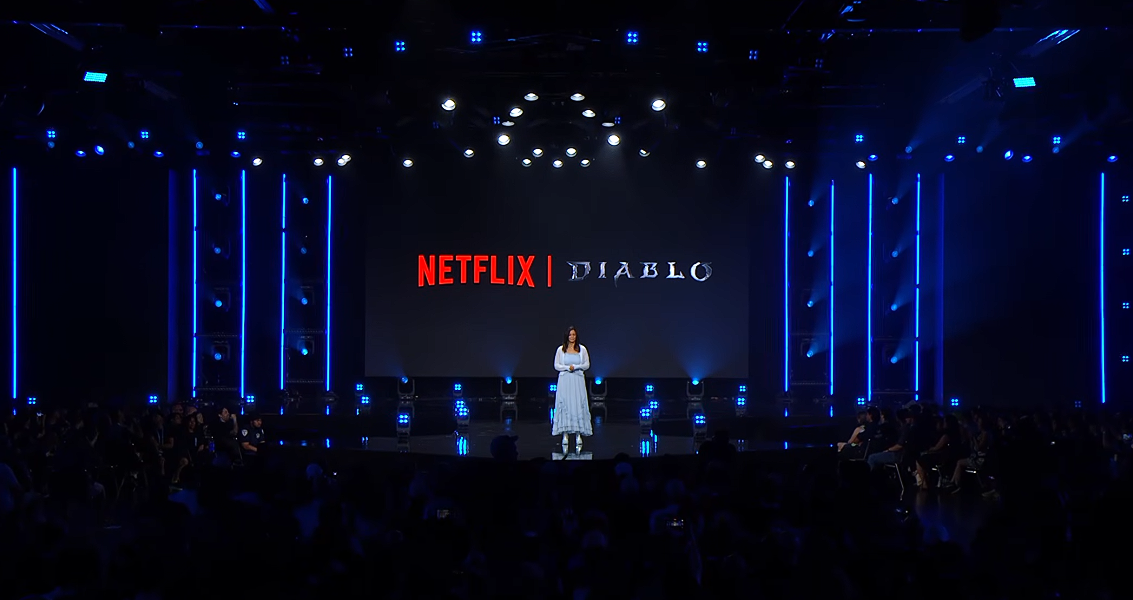 Johanna Faries on stage at BlizzCon 2026, with a screen showing the Netflix and Diablo logos together