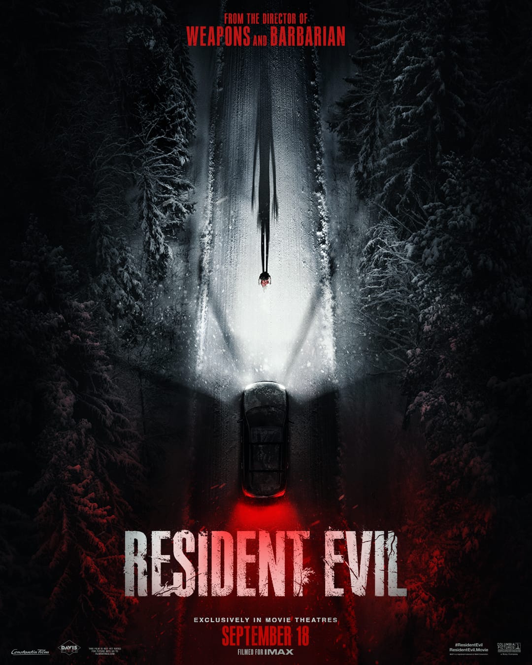 A poster for the Resident Evil movie, showing a car from above, driving in snow with red light behind it and a woman in front of the car