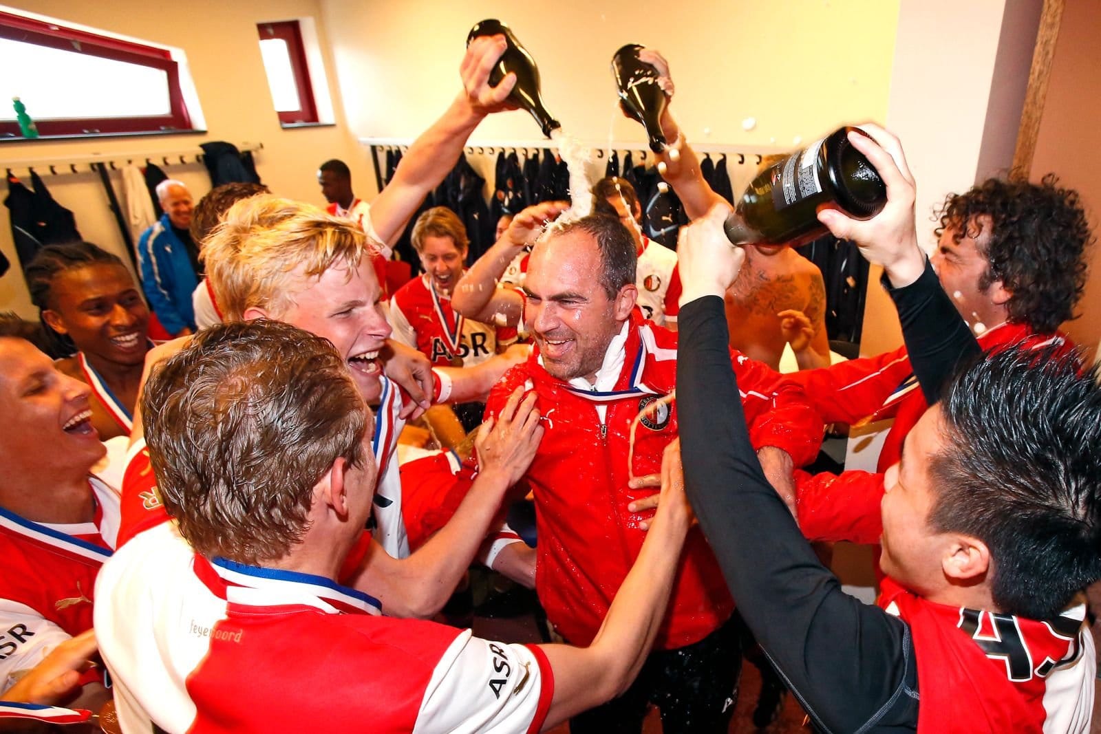 Damien Hertog celebrates with Feyenoord players in the dressing room after winning the U-19 Dutch national championship