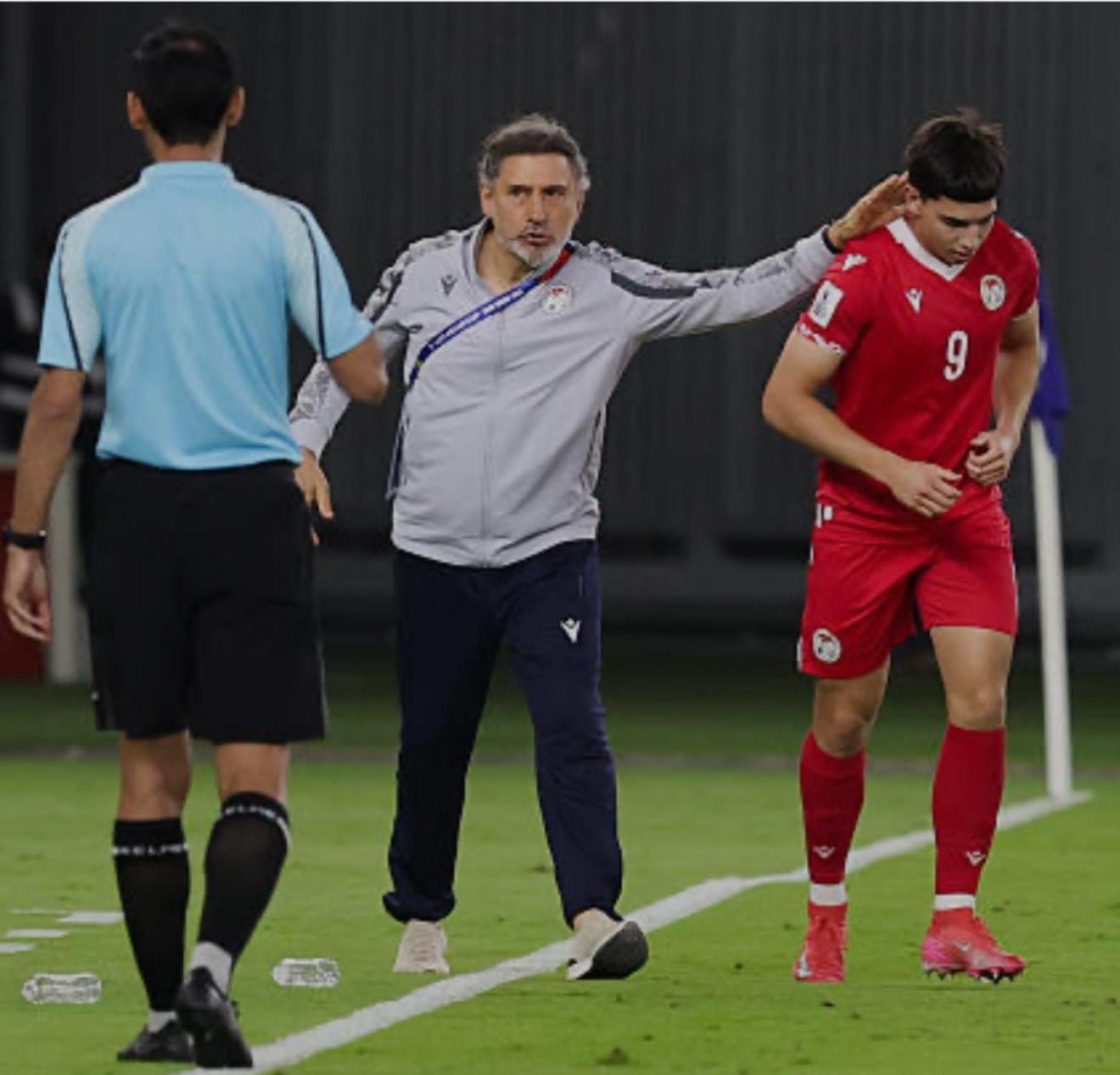 Marco Ragini directs play from the touchline during a Tajikistan national team match