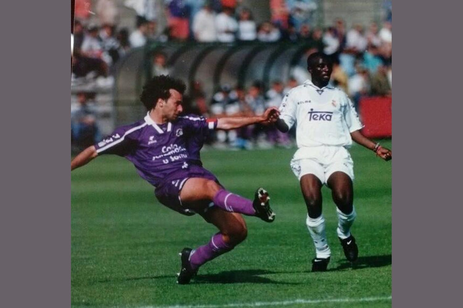 A young Miguel Torrecilla as a professional defender in a purple away kit, sliding to challenge an opponent wearing a white Real Madrid shirt during a 1990s LaLiga match.