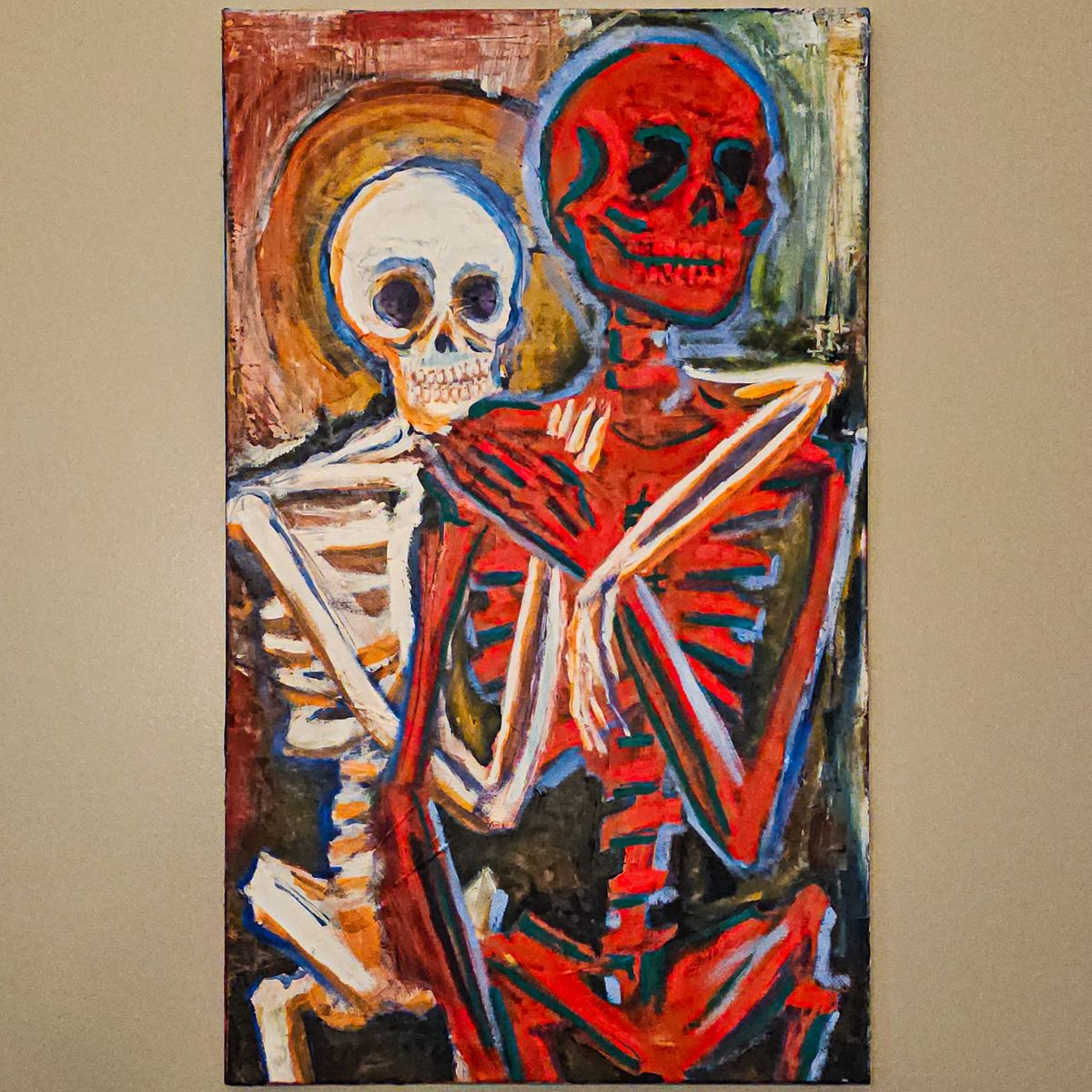 a white and gold skeleton embracing a red and green skeleton