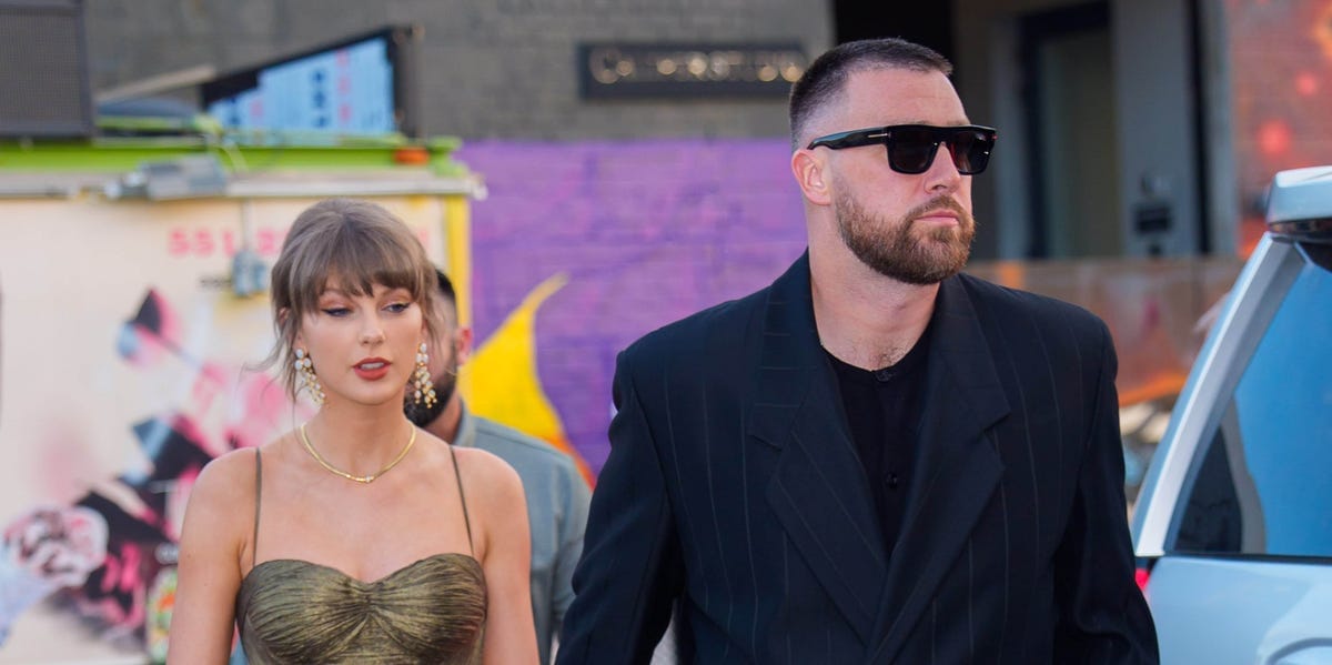 Taylor Swift Throws Travis Kelce’s Jacket Over Her Shimmering Gold Dress