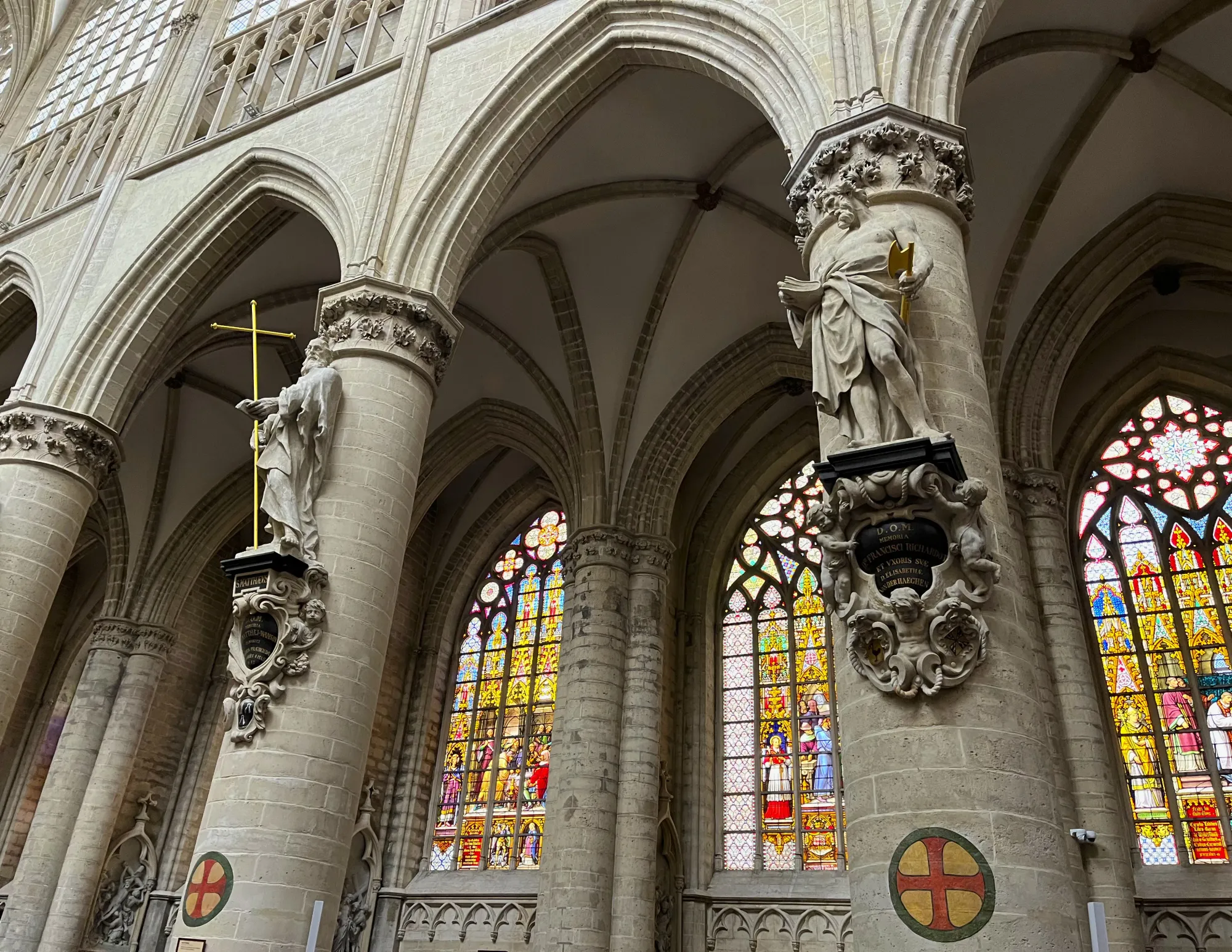 Grey stone columns with statues of saints on them