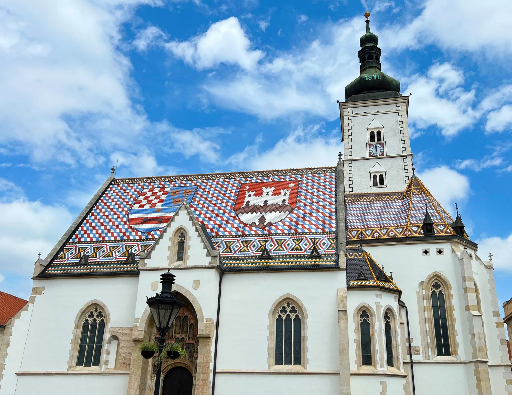 Blue, White, and Red tiled roof on a white church