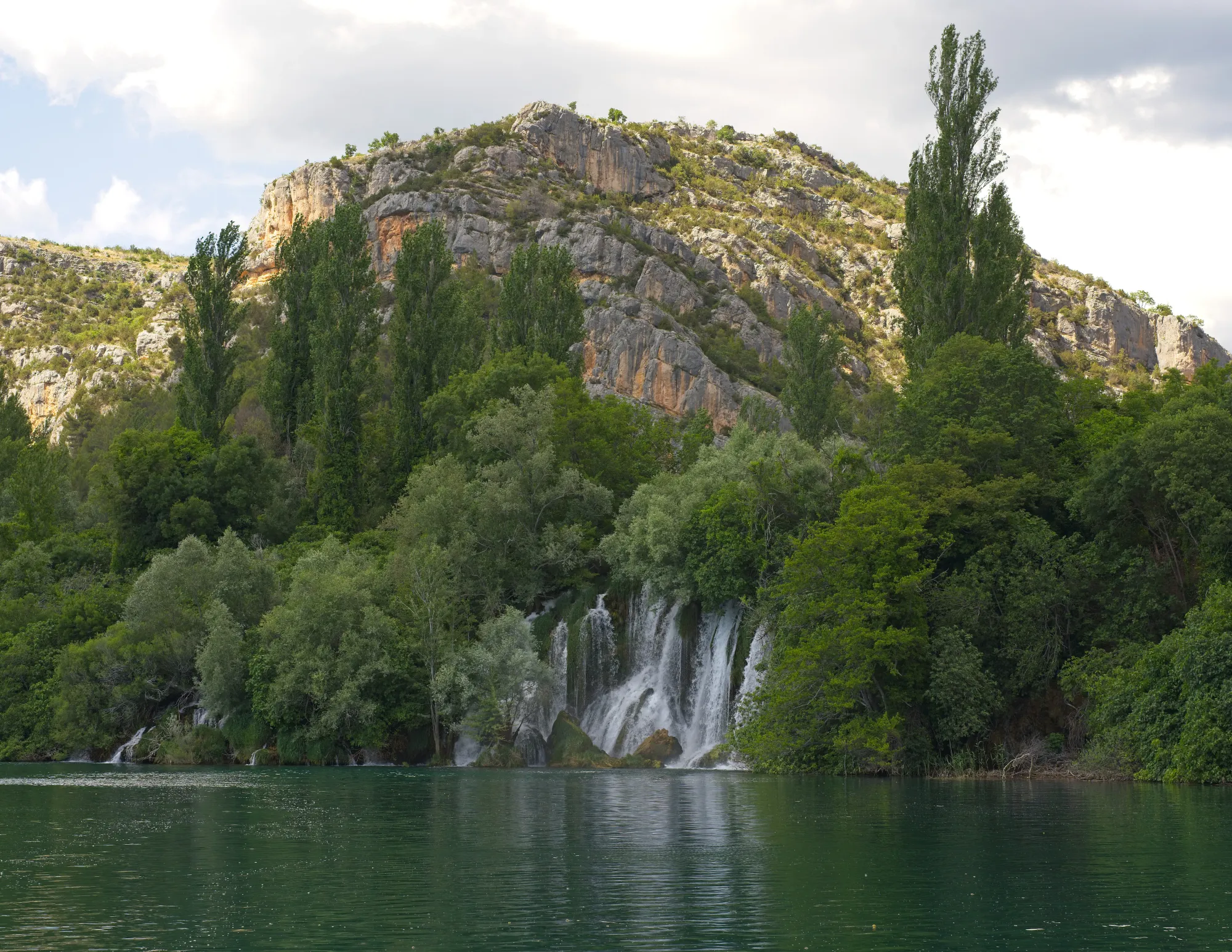 Waterfall with a mountain set behind it