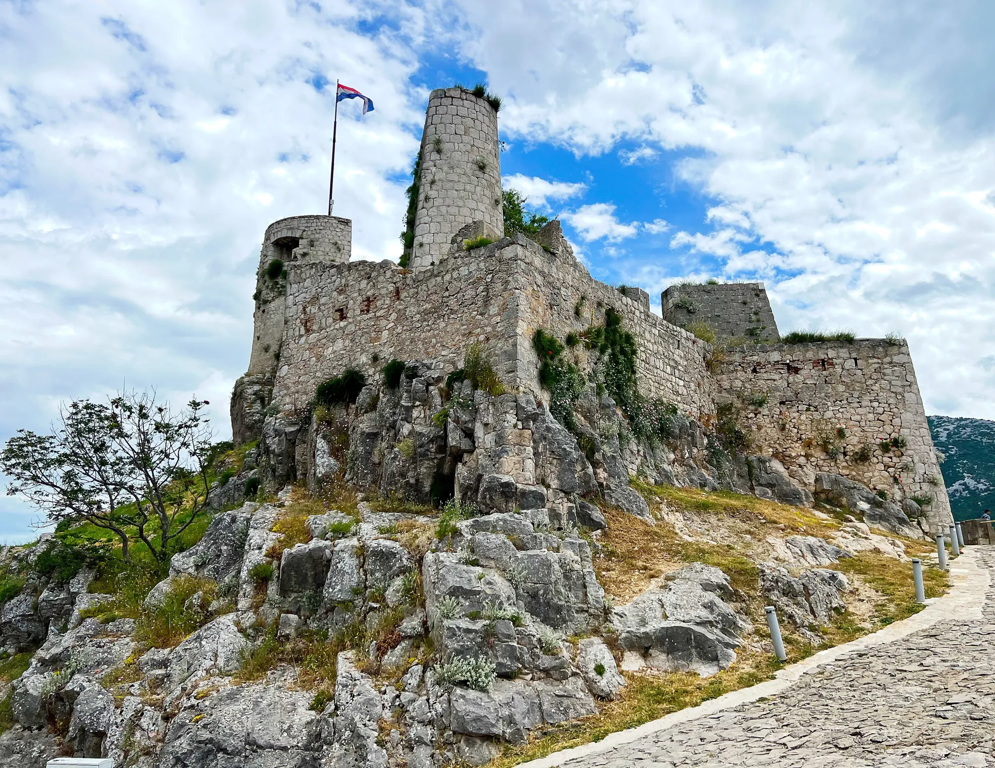 Stone medieval fortress set against a cloudy sky