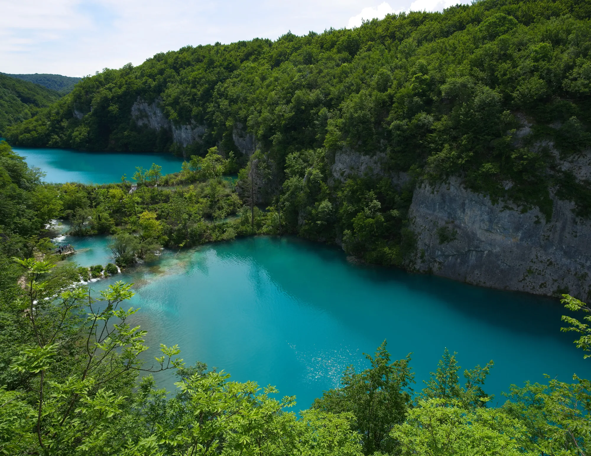 Aqua water cascading between terraced lakes