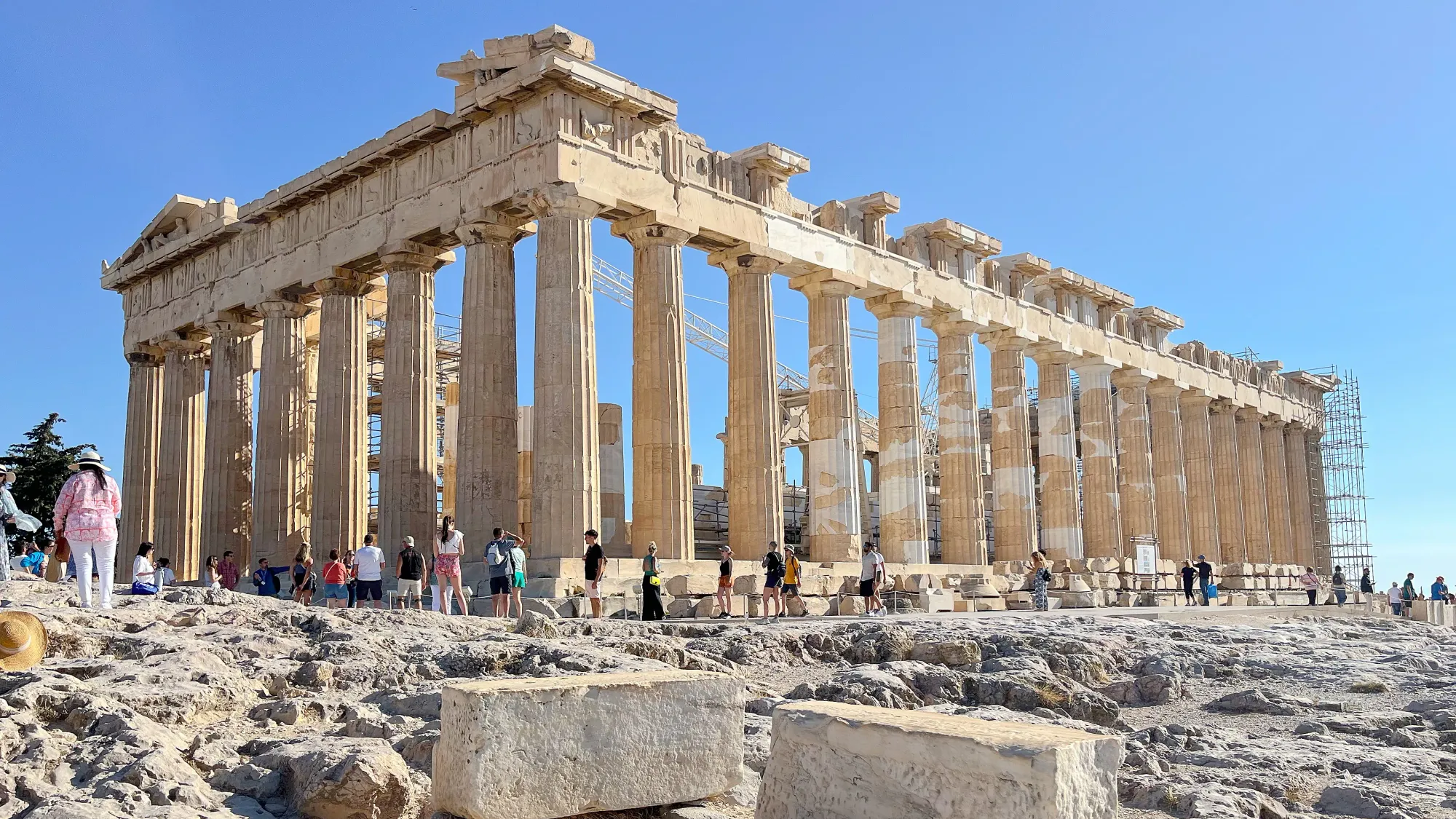 Columned stone ruins surrounded by tourists