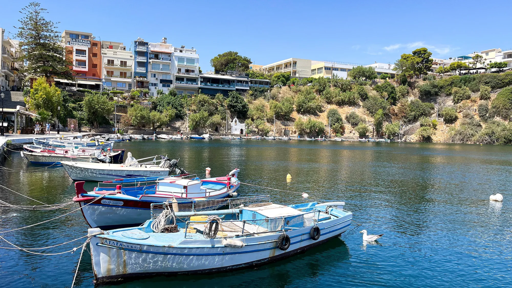 Blue bay with small boats moored along its side